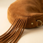 Close-up of fringe stitching and texture on Brown bag with fringe tassel