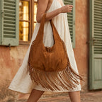 Woman wearing Brown bag with fringe tassel with swaying fringe