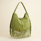 Green bag with fringe tassel, three-quarter angle showing side depth