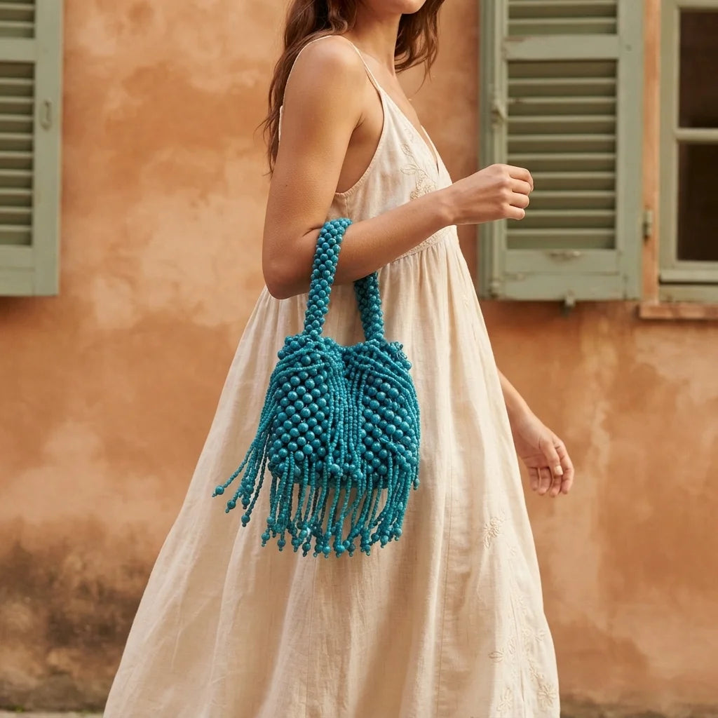 Woman wearing Blue beaded fringe clutch bag with swaying fringe