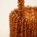 Close-up of fringe stitching and texture on Brown beaded fringe clutch bag