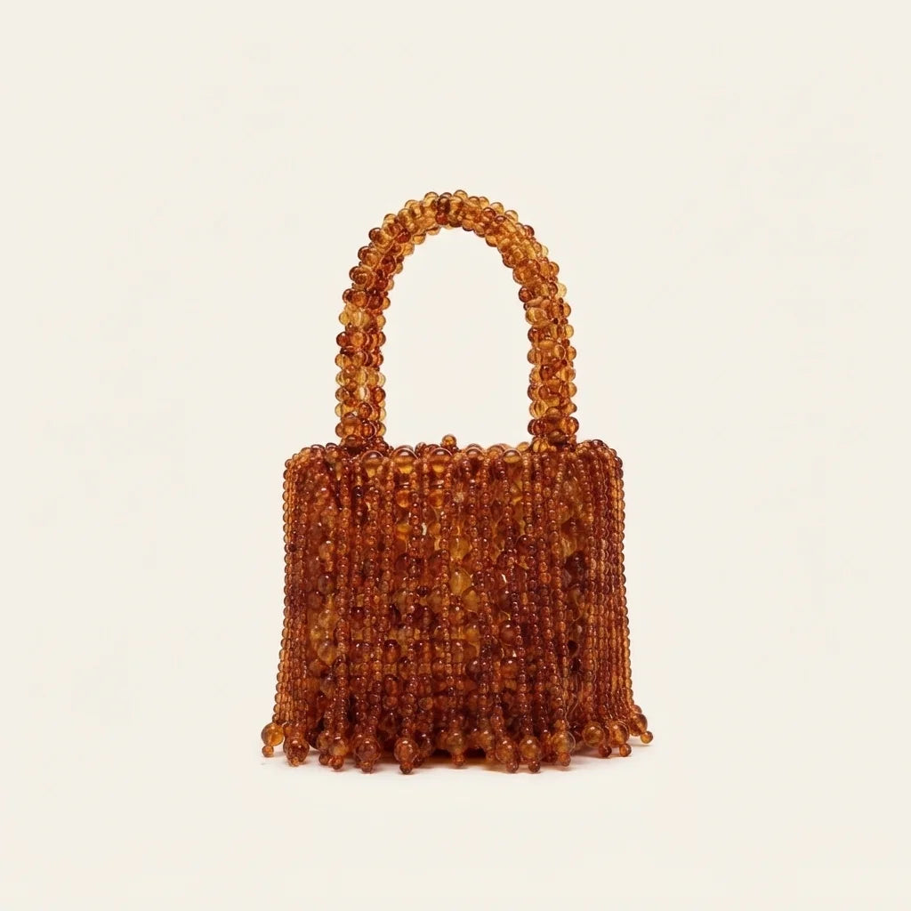 Brown beaded fringe clutch bag, three-quarter angle showing side depth