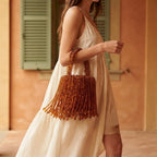 Woman wearing Brown beaded fringe clutch bag with swaying fringe