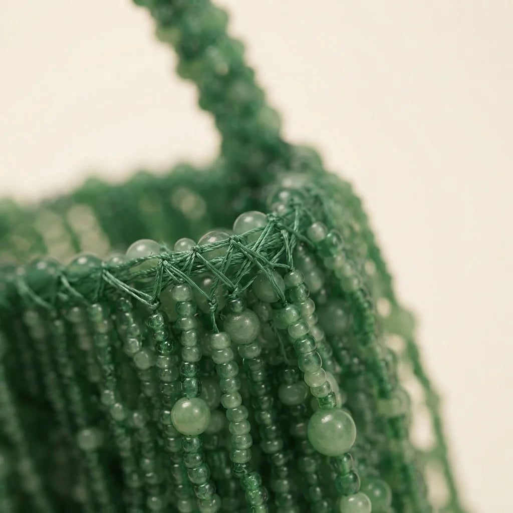 Close-up of fringe stitching and texture on Green beaded fringe clutch bag