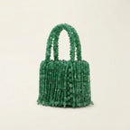 Green beaded fringe clutch bag, three-quarter angle showing side depth