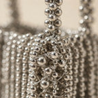 Close-up of fringe stitching and texture on Silver Grey beaded fringe clutch bag