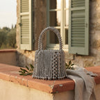 Silver Grey beaded fringe clutch bag styled in a warm Mediterranean setting