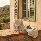 White beaded fringe shoulder bag styled in a warm Mediterranean setting