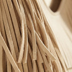 Close-up of fringe stitching and texture on Beige beige fringe bag