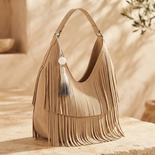Beige beige fringe bag, three-quarter angle showing side depth