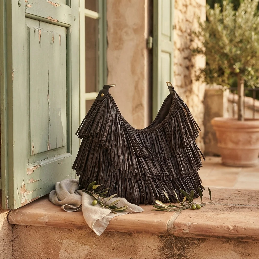 Chocolate big brown fringe bag styled in a warm Mediterranean setting