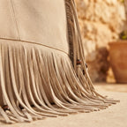 Close-up of fringe stitching and texture on Beige big fringed shoulder bag