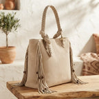 Beige big fringed shoulder bag, three-quarter angle showing side depth