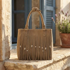Khaki big fringed shoulder bag styled in a warm Mediterranean setting
