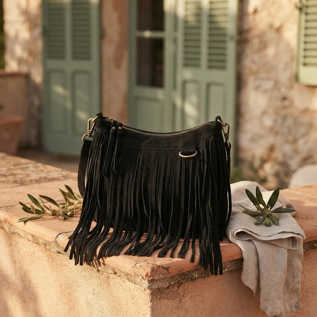 Black black fringe bag suede styled in a warm Mediterranean setting