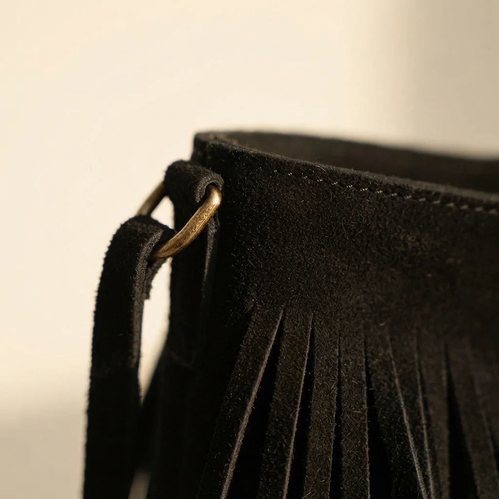 Close-up of fringe stitching and texture on Black black fringe bucket bag