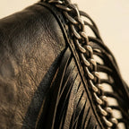 Close-up of fringe stitching and texture on Black black fringe clutch bag