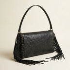 Black black fringe clutch bag, three-quarter angle showing side depth