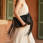 Woman wearing Black black fringe clutch bag with swaying fringe