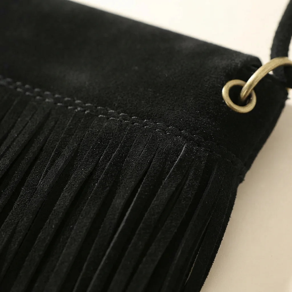 Close-up of fringe stitching and texture on Black black fringe messenger bag