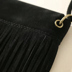 Close-up of fringe stitching and texture on Black black fringe messenger bag