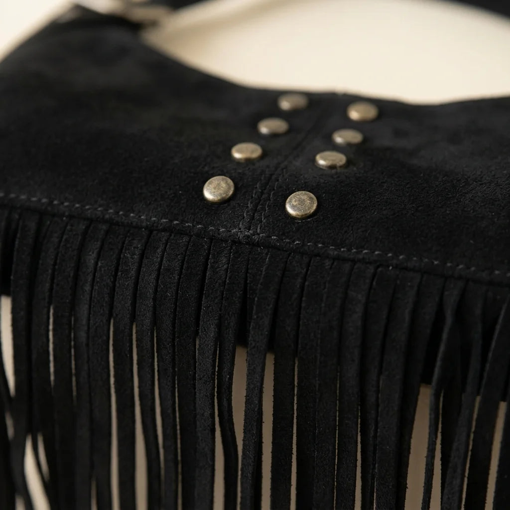 Close-up of fringe stitching and texture on Black black fringe shoulder bag