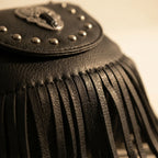 Close-up of fringe stitching and texture on Black black fringe tassel across body bag