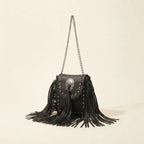 Black black fringe tassel across body bag, three-quarter angle showing side depth