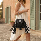 Woman wearing Black black fringe tassel across body bag with swaying fringe