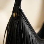 Close-up of fringe stitching and texture on Black black leather fringe bag