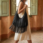 Woman wearing Black black leather fringe bag with swaying fringe