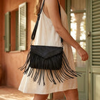 Woman wearing Black black leather fringe crossbody bag with swaying fringe