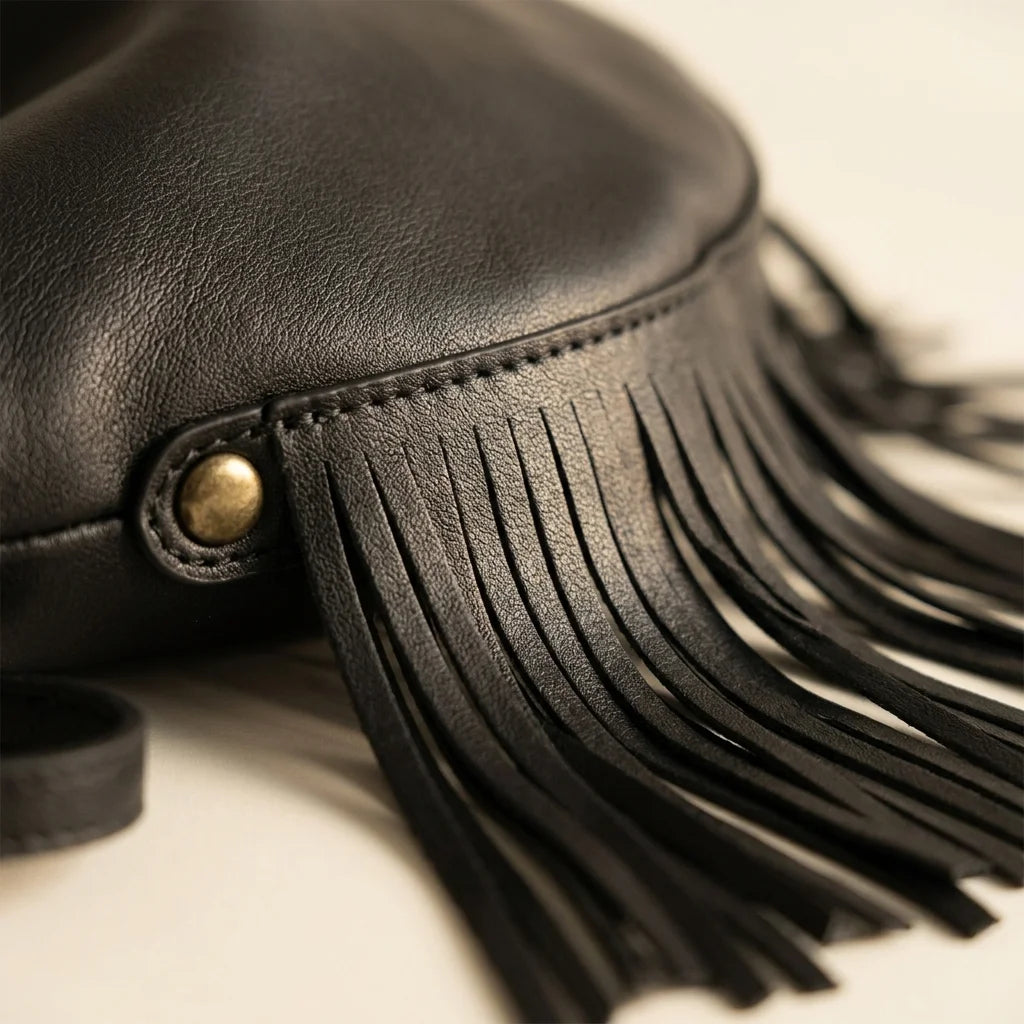 Close-up of fringe stitching and texture on Black black leather fringe hobo bag