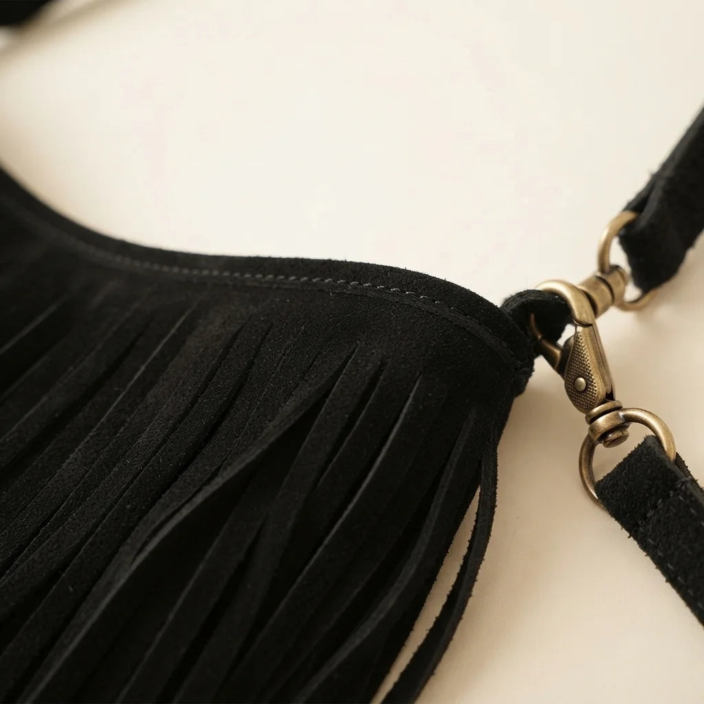 Close-up of fringe stitching and texture on Black black suede fringe hobo bag