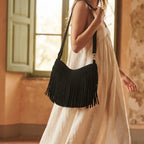 Woman wearing Black black suede fringe hobo bag with swaying fringe