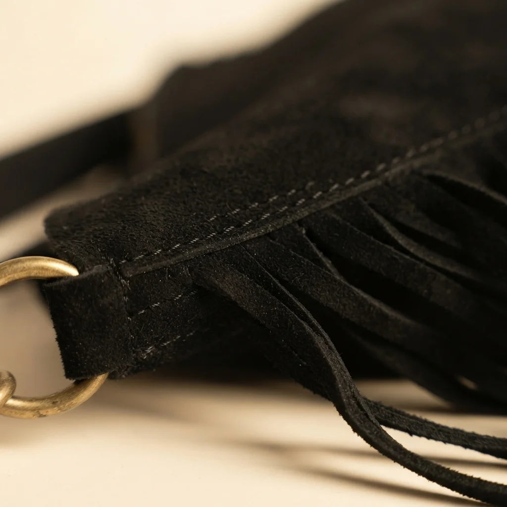 Close-up of fringe stitching and texture on Black bohemian fringe bag