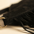 Close-up of fringe stitching and texture on Black bohemian fringe bag