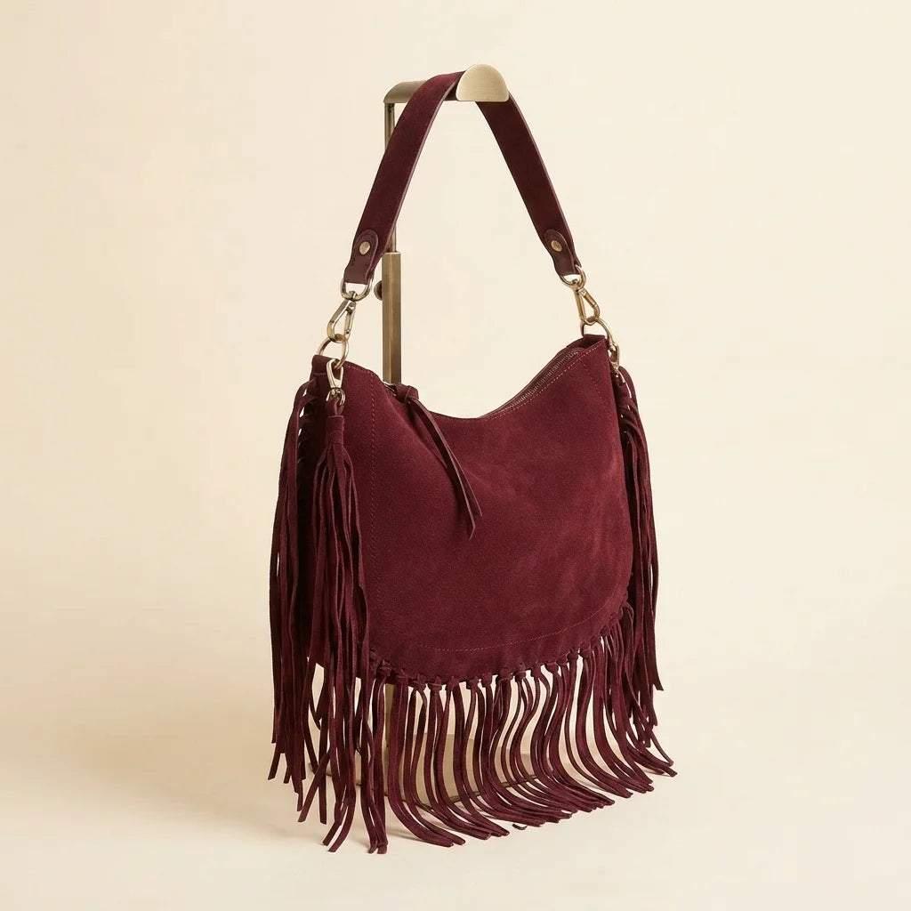 Burgundy bohemian fringe bag, three-quarter angle showing side depth