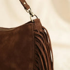 Close-up of fringe stitching and texture on Chocolate bohemian fringe bag