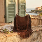Chocolate bohemian fringe bag styled in a warm Mediterranean setting