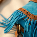 Close-up of fringe stitching and texture on Blue bohemian fringe crossbody bag