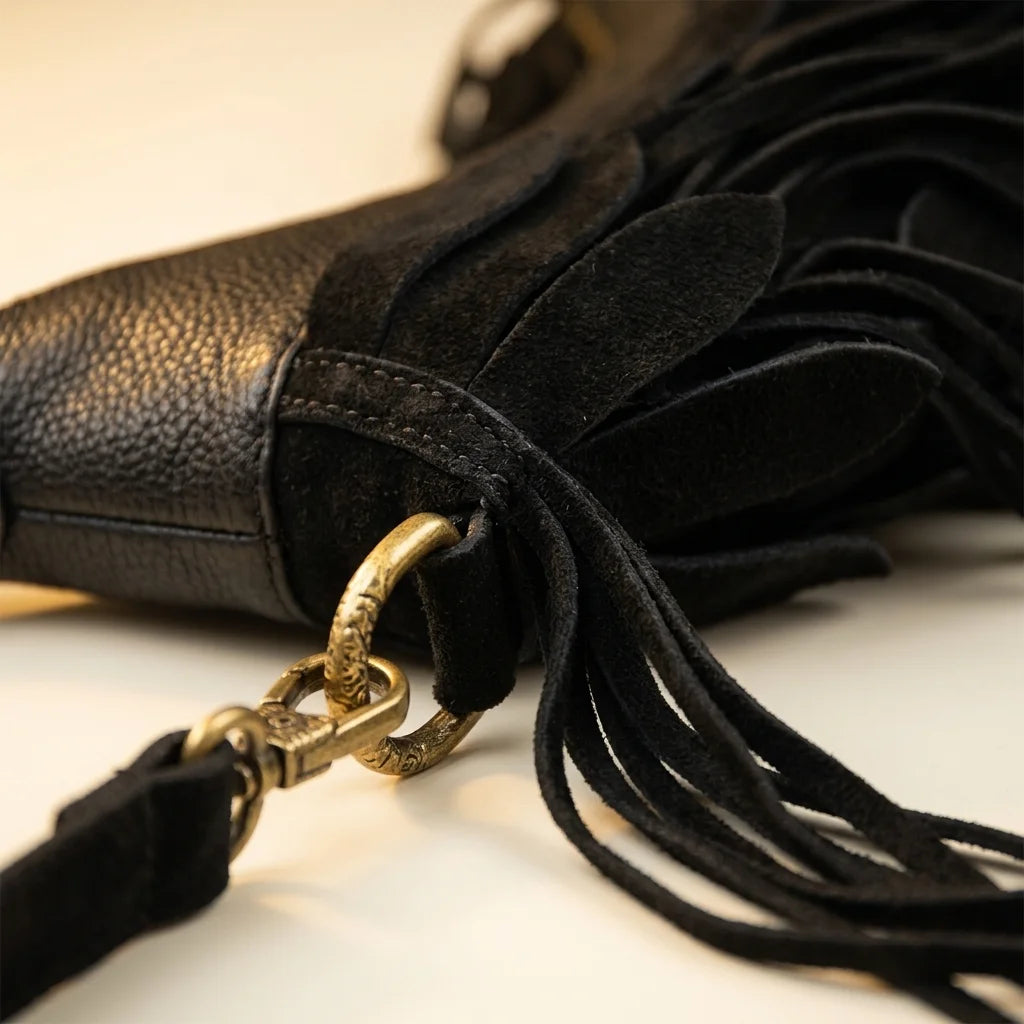 Close-up of fringe stitching and texture on Black bohemian tassel fringe bag
