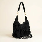 Black bohemian tassel fringe bag, three-quarter angle showing side depth