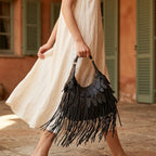 Woman wearing Black bohemian tassel fringe bag with swaying fringe