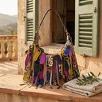 Multicolor bohemian tassel fringe bag styled in a warm Mediterranean setting