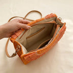 Interior lining and pockets of Orange boho fringe bag clutch