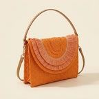 Orange boho fringe bag clutch, three-quarter angle showing side depth