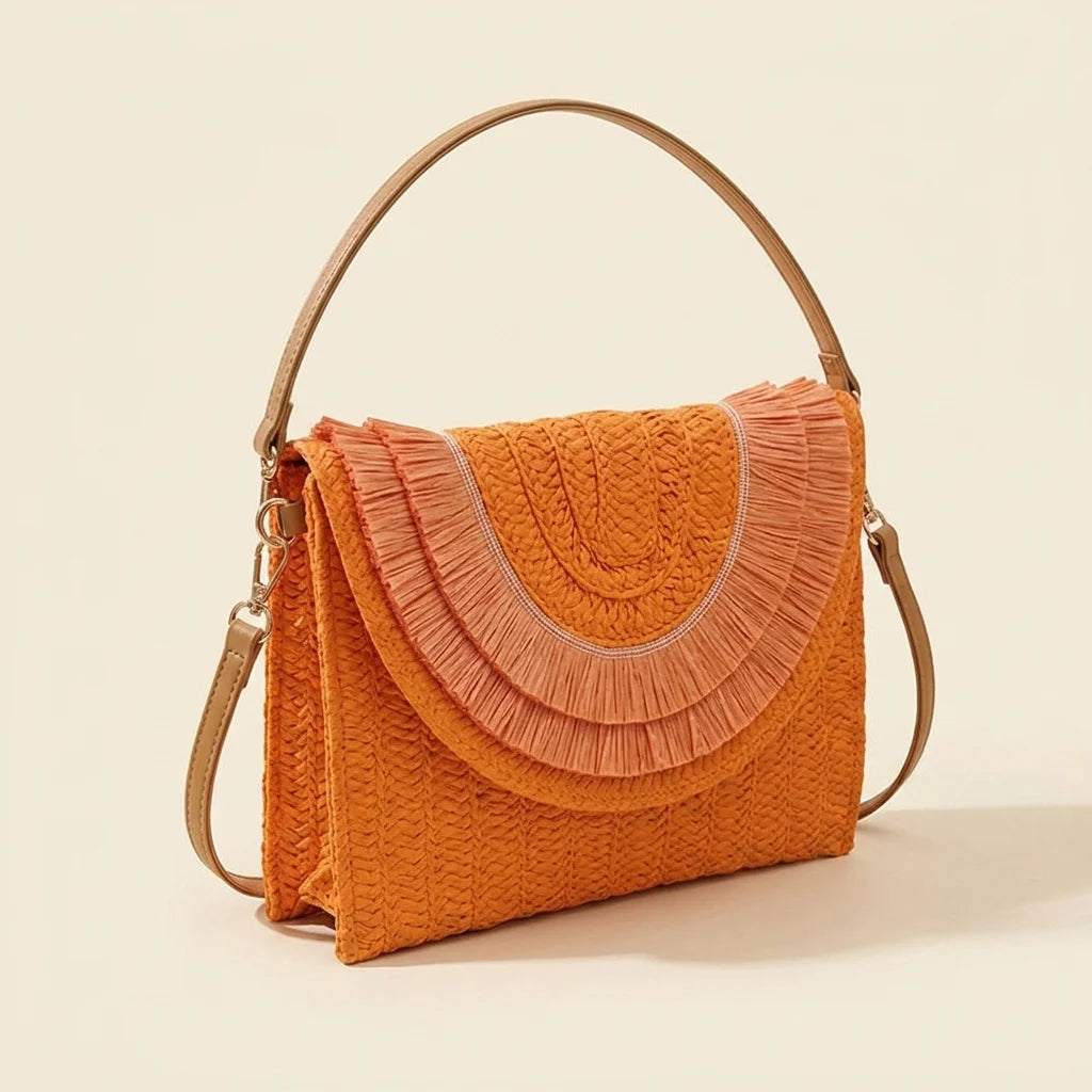 Orange boho fringe bag clutch, three-quarter angle showing side depth