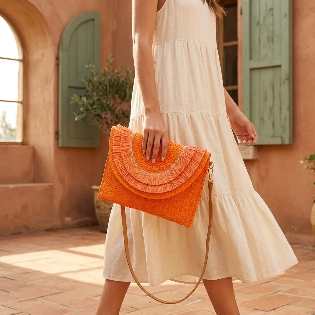 Woman wearing Orange boho fringe bag clutch with swaying fringe