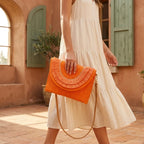 Woman wearing Orange boho fringe bag clutch with swaying fringe
